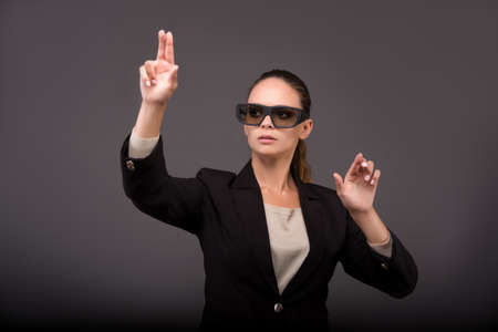 Young woman businesswoman pressing virtual buttons