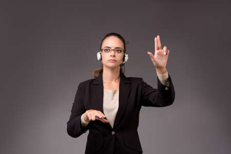 Young woman businesswoman pressing virtual buttonsの写真素材