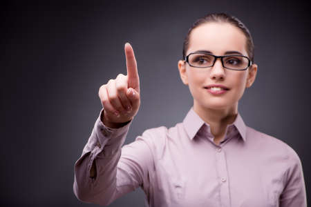 Businesswoman pressing virtual button in business conceptの写真素材