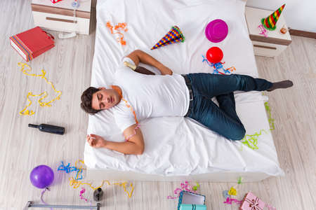 Man after heavy christmas partying at homeの写真素材