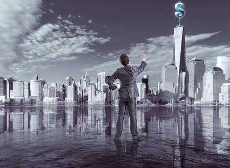 Businessman pressing virtual dollar buttonの写真素材