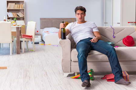 Man after heavy christmas partying at homeの写真素材