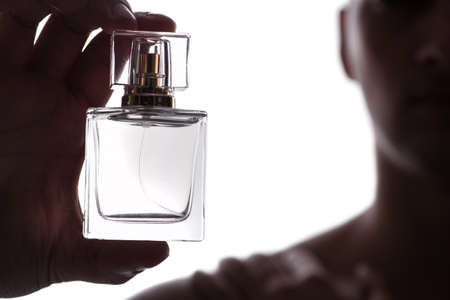 Sexy man with bottle of perfume