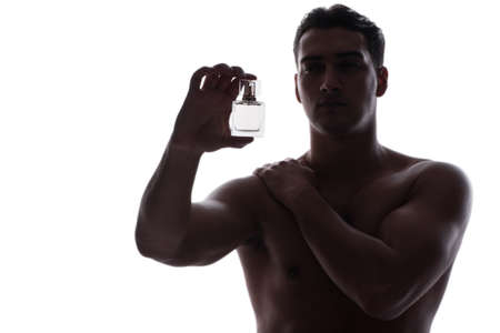 Sexy man with bottle of perfumeの写真素材