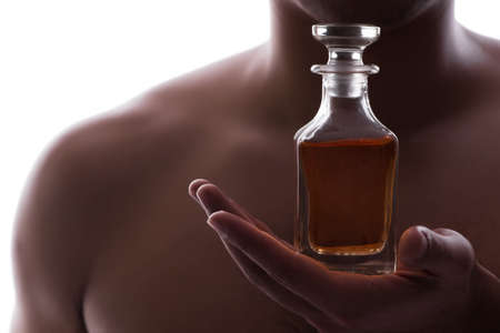 Sexy man with bottle of perfumeの写真素材