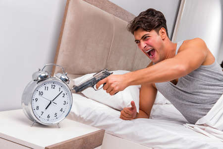 Angry man with gun and clockの写真素材