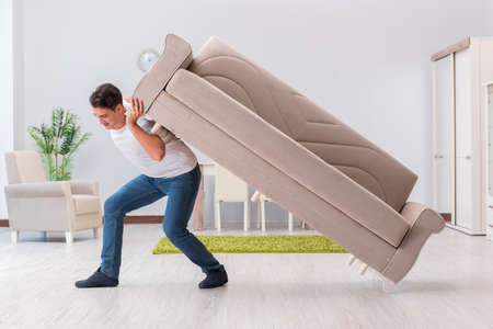 Man moving furniture at homeの写真素材