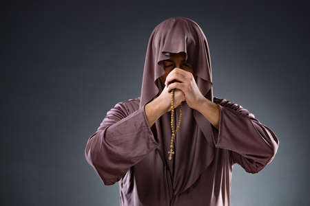 Monk in religious concept on gray backgroundの写真素材