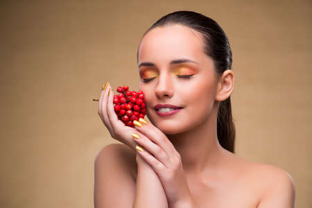 Young pretty woman with berries in beauty conceptの写真素材