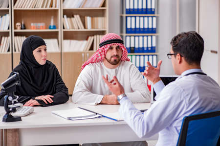 Doctor consulting arab family at hospitalの写真素材