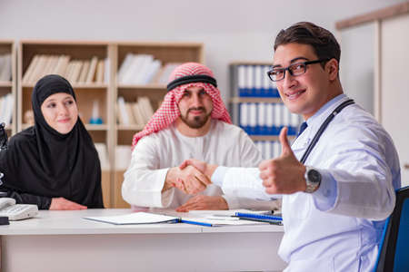 Doctor consulting arab family at hospitalの写真素材