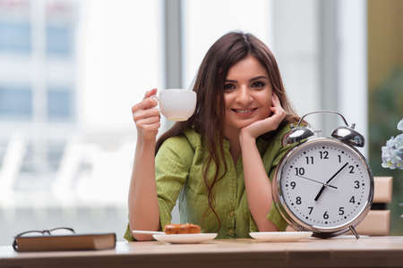 Student with gian alarm clock preparing for exams