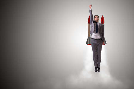 Man flying with the rocket in business concept
