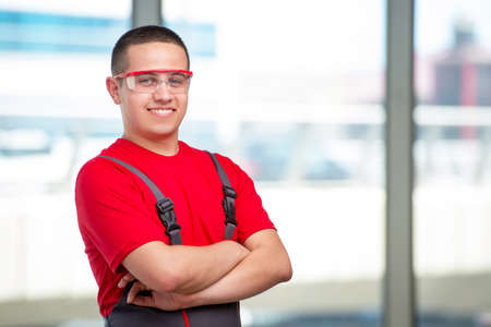 Young furniture carpenter in industrial concept