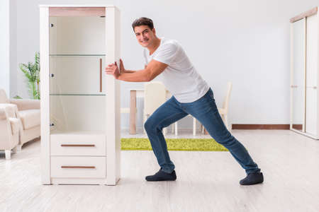 Man moving furniture at homeの写真素材