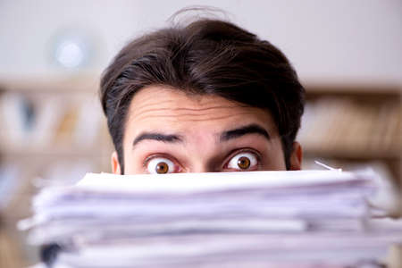 Businessman struggling to meet challenging deadlinesの写真素材