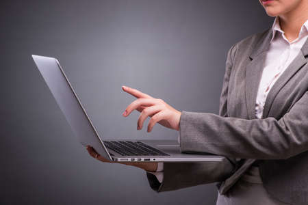 Businesswoman with laptop in business conceptの写真素材