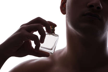 Sexy man with bottle of perfumeの写真素材
