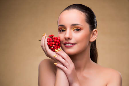 Young pretty woman with berries in beauty conceptの写真素材