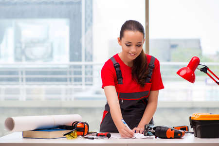 Young woman in coveralls doing repairs