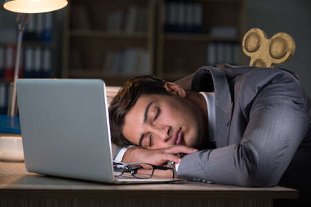 Businessman with key in hardworking concept