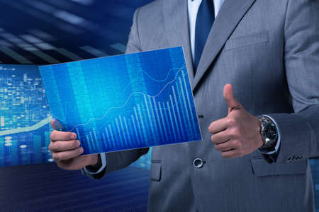 Businessman holding screen with market quotes