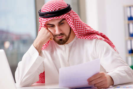 Arab businessman working on laptop computerの写真素材