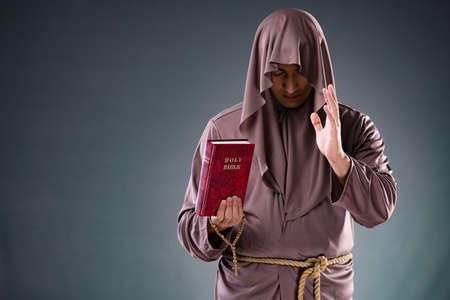 Monk in religious concept on gray backgroundの写真素材