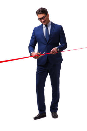 Businessman cutting red ribbon isolated on whiteの写真素材
