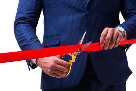 Businessman cutting red ribbon isolated on whiteの写真素材