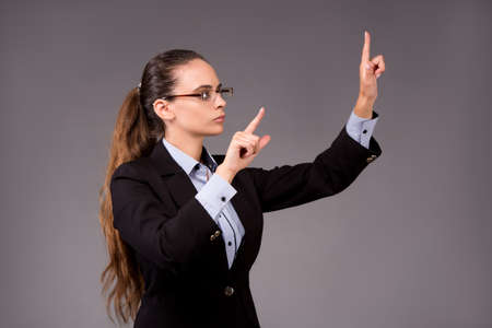Young woman businesswoman pressing virtual buttonsの写真素材