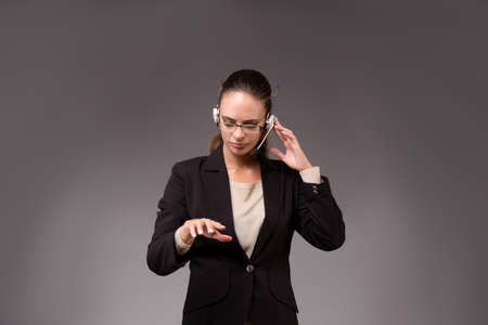Young woman businesswoman pressing virtual buttonsの写真素材