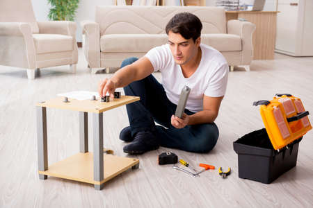 Man assembling shelf at homeの写真素材