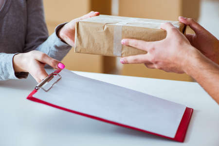 Delivery man delivering parcel boxの写真素材