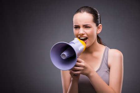 Woman in sports concept with loudspeakerの写真素材