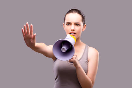 Woman in sports concept with loudspeakerの写真素材