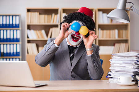 Clown businessman working in the officeの写真素材
