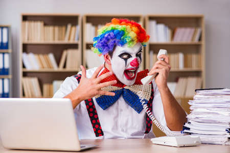 Clown businessman working in the officeの写真素材
