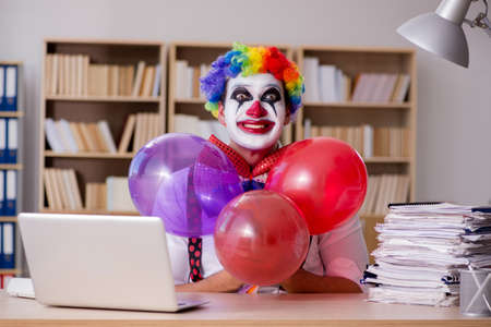 Clown businessman working in the officeの写真素材