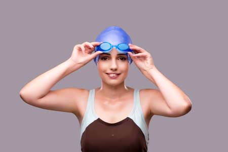 Woman swimmer against grey backgroundの写真素材