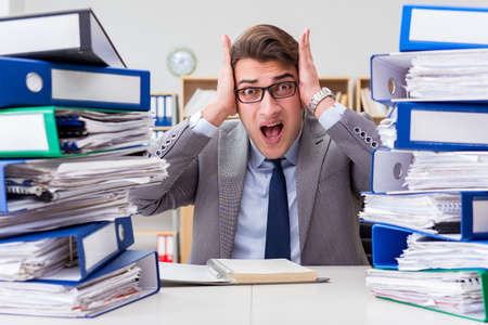 Busy businessman under stress due to excessive work