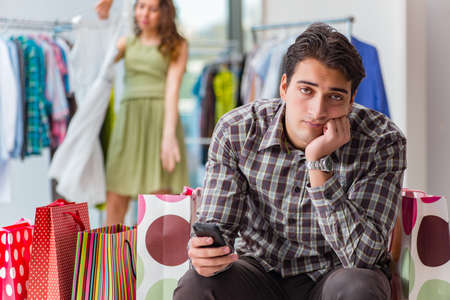 Man fed up with wife shopping in shopの写真素材