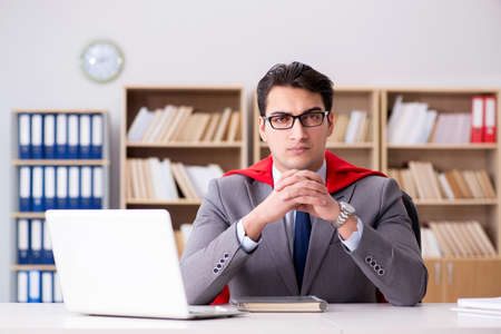 Superhero businessman working in the officeの写真素材