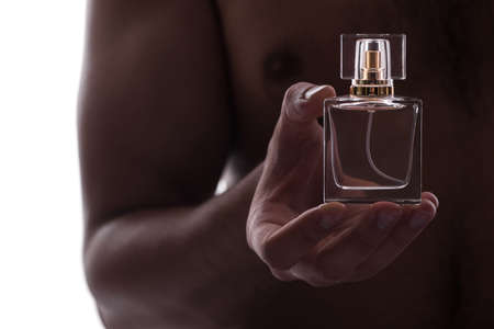 Sexy man with bottle of perfumeの写真素材