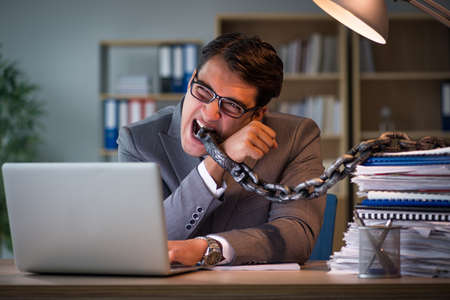 Businessman staying in the office for long hoursの写真素材