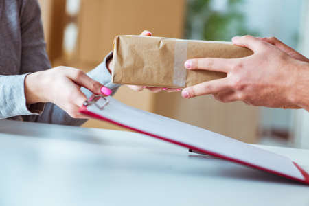 Delivery man delivering parcel boxの写真素材