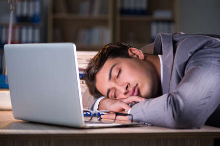 Businessman staying in the office for long hoursの写真素材