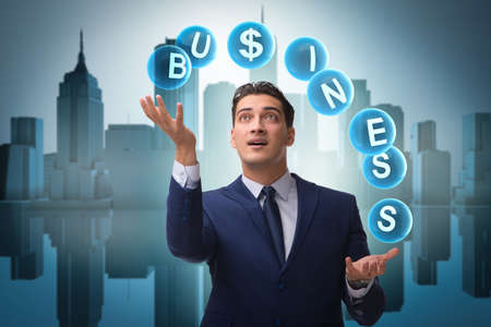 Businessman juggling between various priorities in businessの写真素材