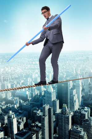 Businessman doing tightrope walking in risk conceptの写真素材