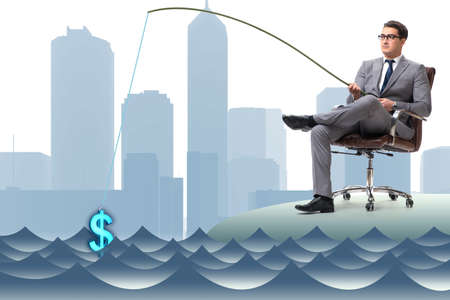 Businessman fishing out dollars from waterの写真素材